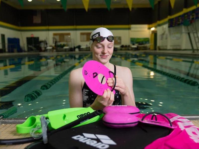 How to use a pull buoy: swimmer fixing her swimming equipments