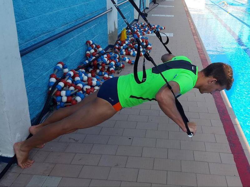 Man doing push-ups using a TRX