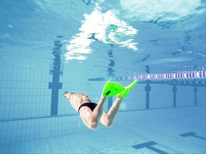 Swimming with fins workout: underwater shot of a swimmer using swim fins