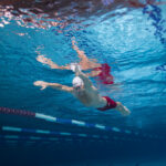 A man swims the breaststroke in a pool