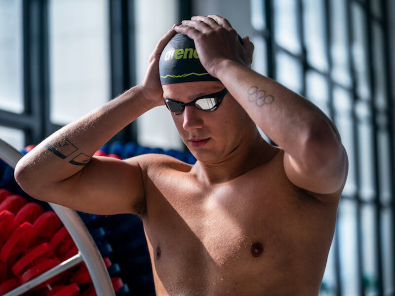 Swimmer adjusting his swim cap