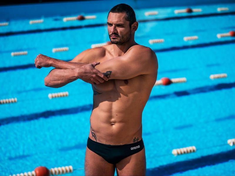 Swimming warmup exercises: swimmer stretching his arm