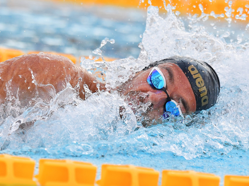 How to increase lung capacity for swimming: swimmer coming up for air