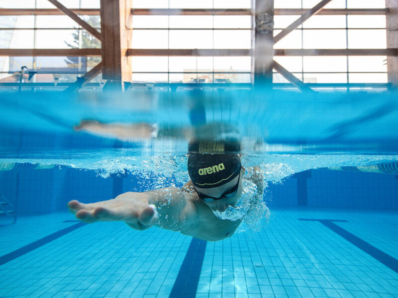 How to increase lung capacity for swimming: underwater shot of swimmer doing the freestyle