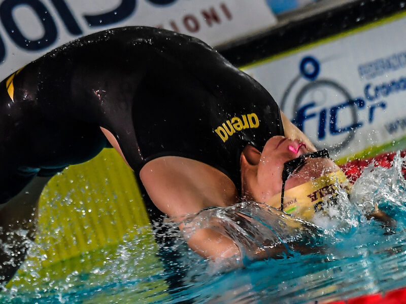 Swimmer entering the pool in a backstroke position