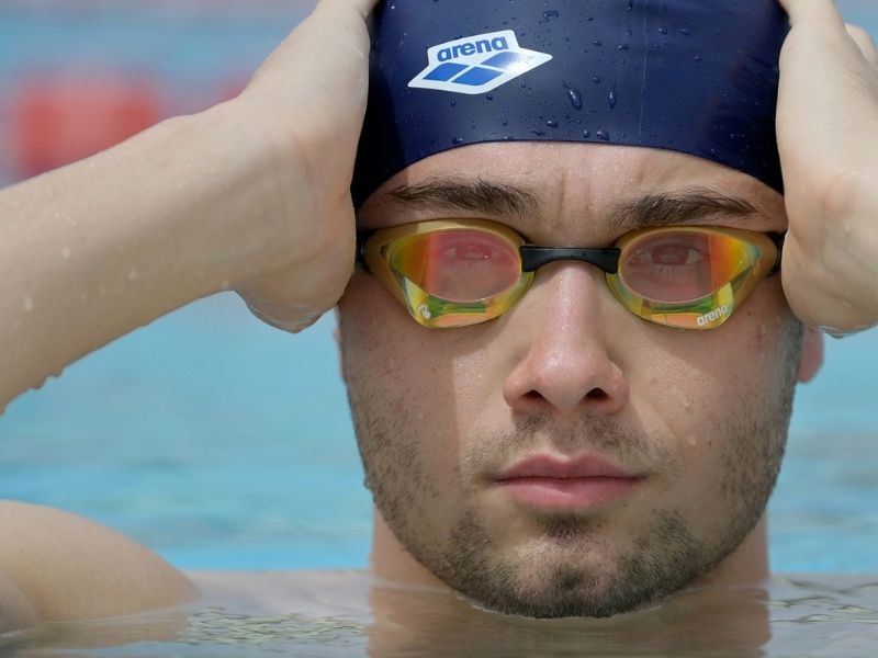 Breaststroke fins: A swimmer wears googles and a cap in the pool