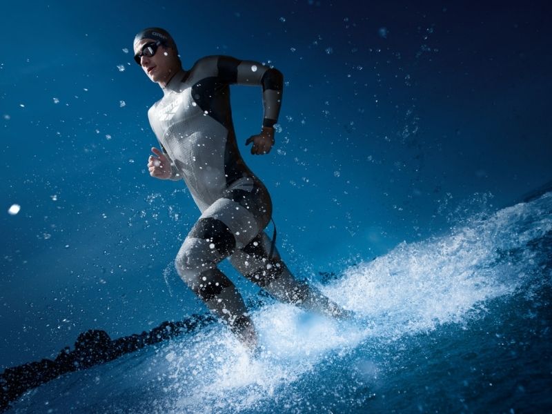 A swimmer running through shallow water