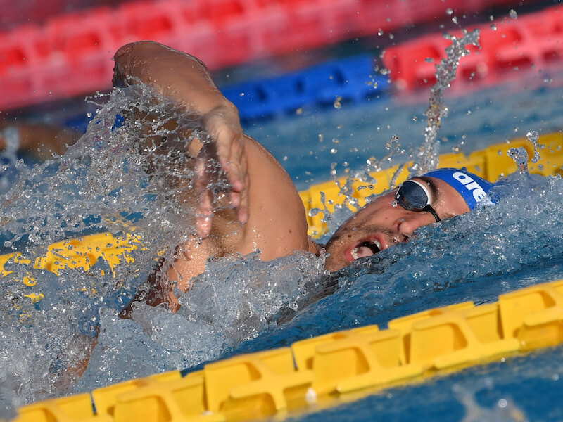 Close-up shot of a swimmer taking a breath during a freestyle stroke