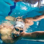 Swimming drills for beginners: underwater shot of a person swimming in a pool