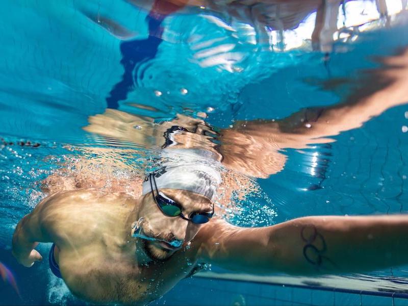 Swimming drills for beginners: underwater shot of a person swimming in a pool