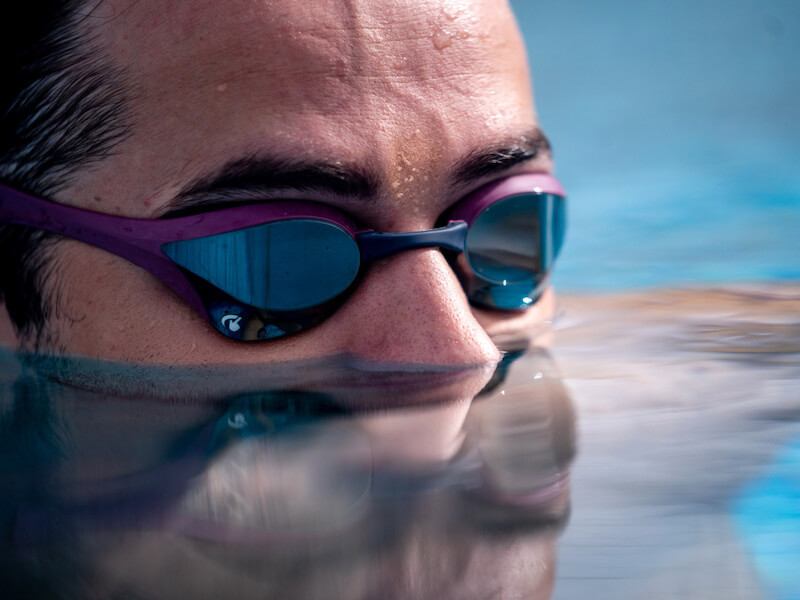 What is sculling in swimming: half of a swimmer's face submerged underwater