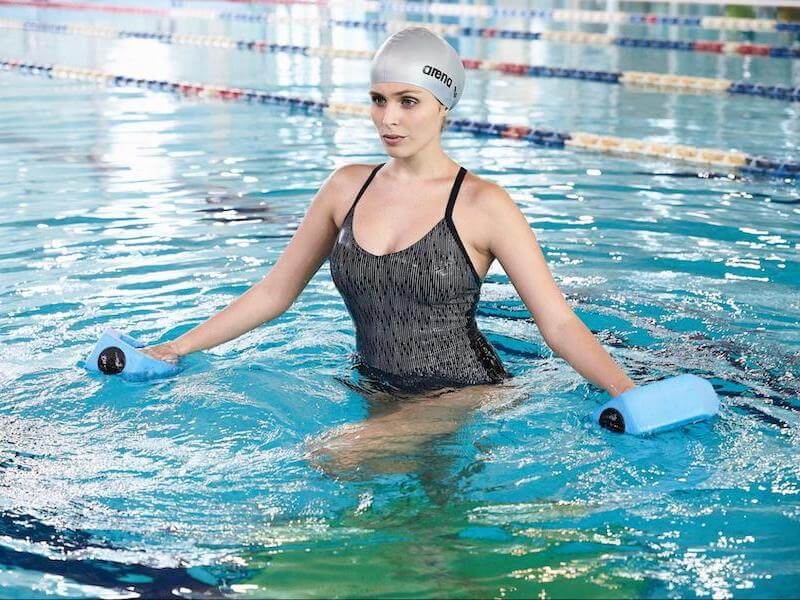 Swimmer using water dumbbells