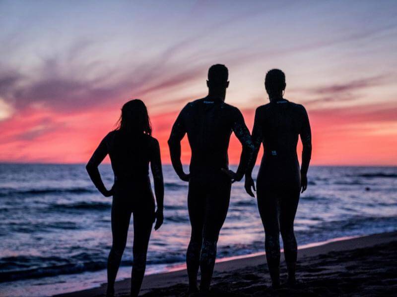 Swimmers looking into the sea