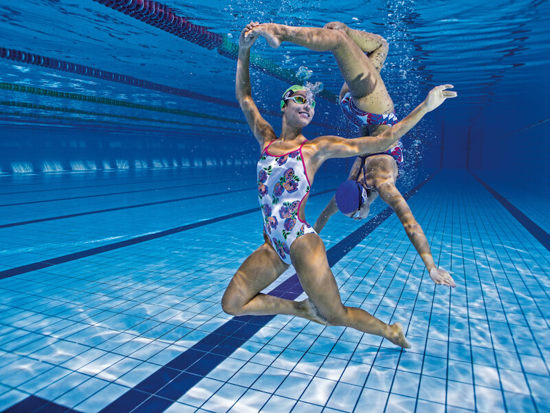 Two swimmers dancing underwater