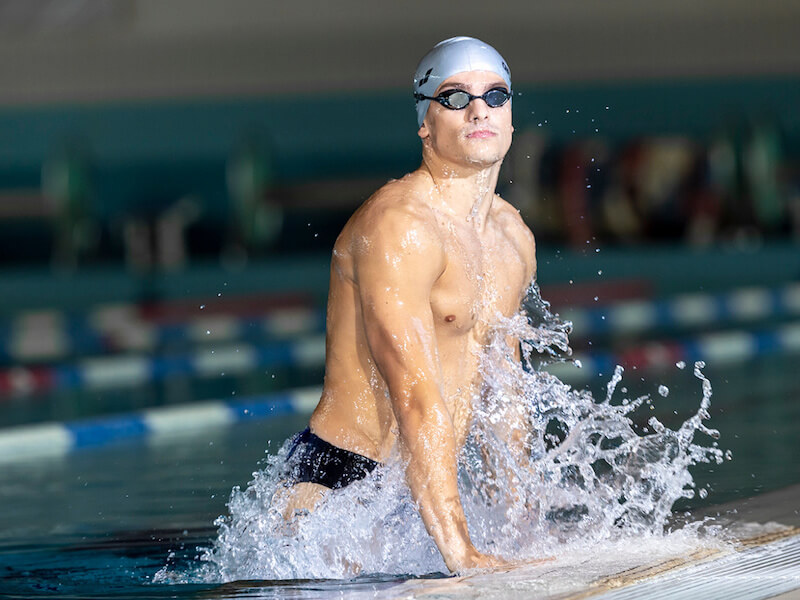 Swimmer getting out of a swimming pool