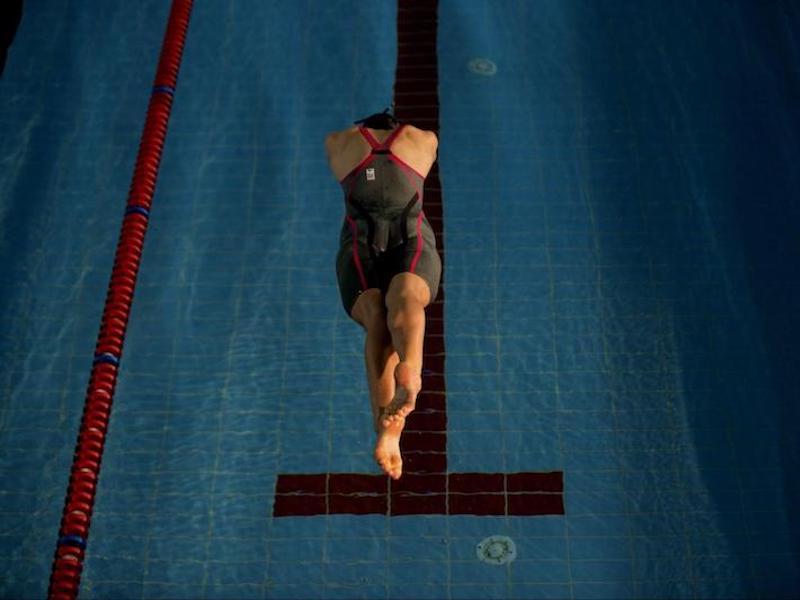 Person diving into a pool