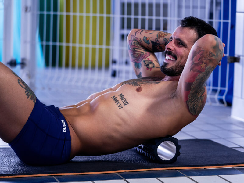 Swimmer using rollers for his back